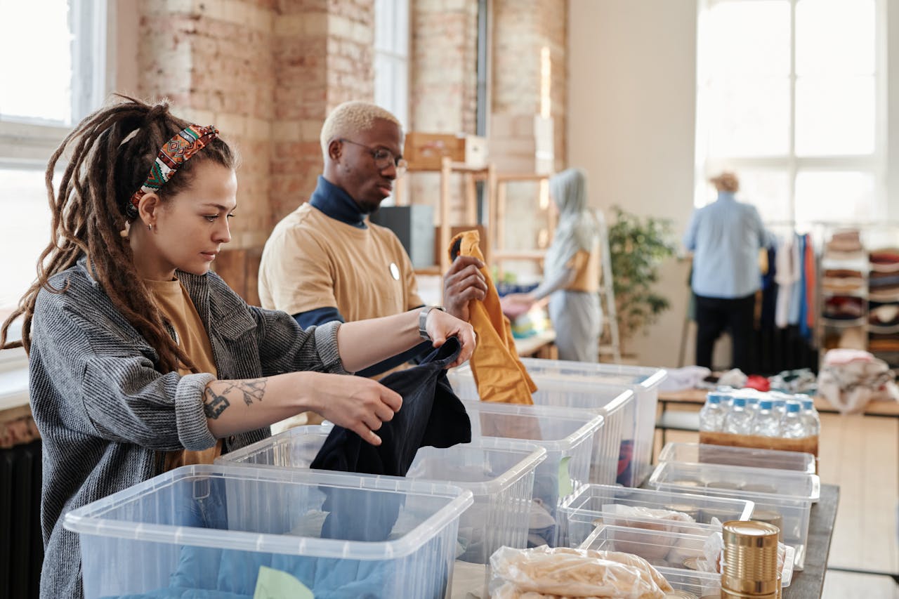 our-services-2 Volunteers organize donated clothing at a donation center, fostering community support and sustainability.